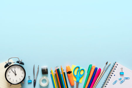 Back to school, stationery on blue background. Image with copy space.