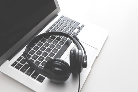 Support headset and laptop in call center. Helpdesk operator desktopの写真素材