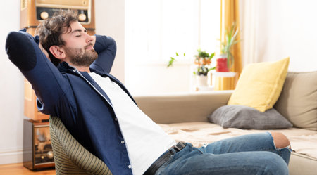 Young man relaxing in his chair in vintage decorated room