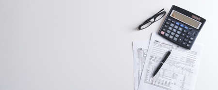 US Individual income tax return. US tax forms on desk. Wide image with copy spaceの写真素材