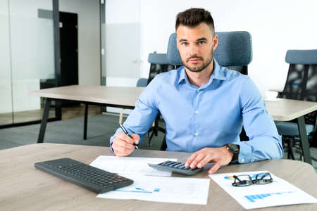 Businessman, accountant working in office. Bookkeeping conceptの写真素材