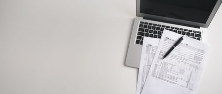US Individual income tax return. US tax forms on desk. Wide image with copy space