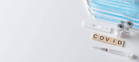 Vaccination concept, coronavirus vaccination, medical equipment, COVID word from wooden tiles