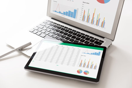 Business analytics applications on tablet and laptop. Financial data analysis concept