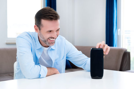 Man using smart speaker, smart home system appliance, modern assistant