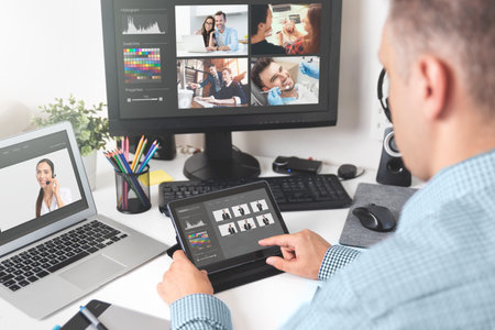 Photographer working with photos, selecting, retouching. Professional photographyの写真素材