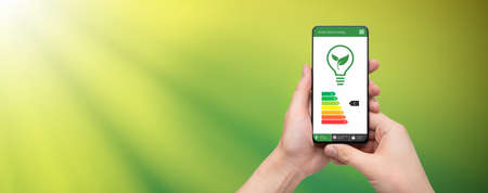Energy efficiency mobile app on screen. Ecology, eco house conceptの写真素材