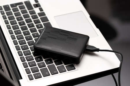 External backup disk hard drive connected to laptopの写真素材
