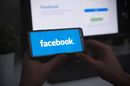 Wroclaw, Poland - JAN 27, 2022: Man using Facebook appication on Huawei P30 smart phone. Facebook is most popular social media service.のeditorial素材