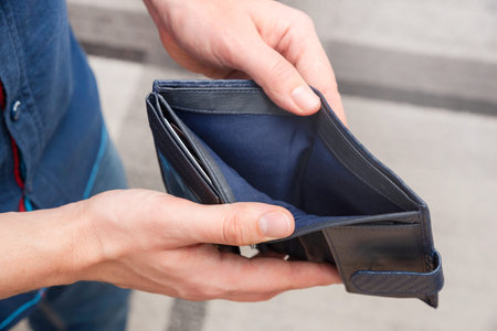Empty wallet held in hands. Lack of money, poverty concept