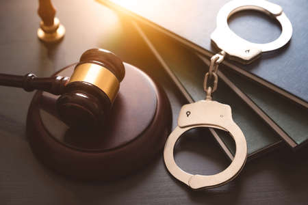Handcuffs and wooden gavel. Crime and violence concept.の写真素材