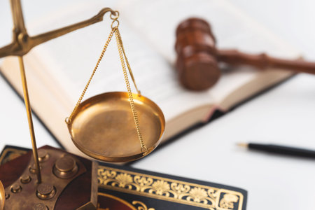Scale and judge gavel on a wooden desk. Law and justice concept