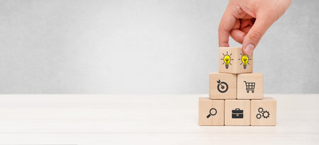 Businessman build company strategy with wooden blocks
