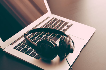 Headset and laptop on desk, call center, helpdesk concept