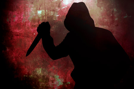 Silhouette criminal holding knife on dirty backgroundの写真素材