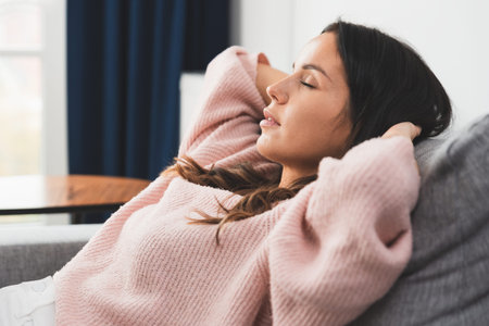 Woman relaxing at home. Young brunette woman thinking at home in a leisure timeの写真素材
