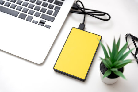 External hard disk connected to laptop. USB drive backup dataの写真素材