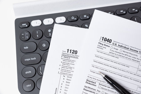 US tax form on computer keyboard. Tax income conceptの写真素材