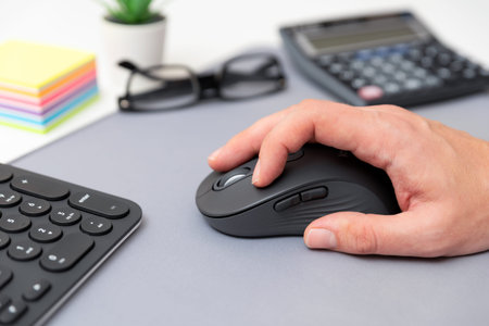 Man using computer mouse. Working at the office