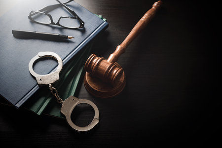 Handcuffs and wooden gavel. Crime and violence.の写真素材