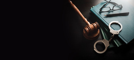 Handcuffs and wooden gavel. Crime and violence.の写真素材