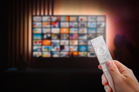 VOD service screen. Man watching TV with remote control in hand.の写真素材