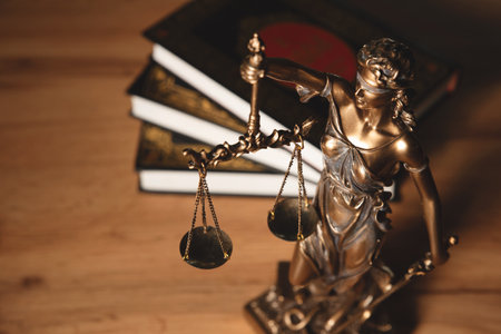 Justice and legal book on wooden table, justice and law conceptの写真素材