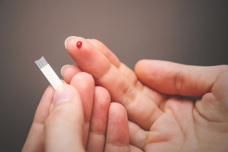 Drop of blood on fingertip for a medical exam. Diabetes disease.の写真素材