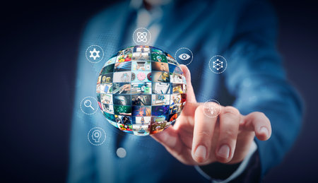 Man pointing multimedia sphere, television and media streaming services conceptの写真素材