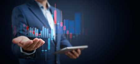 Trading charts on businessman hand. Businessman with tablet, trader conceptの写真素材