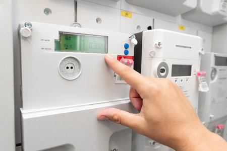 Man showing electric energy meter. Energy bills conceptの写真素材