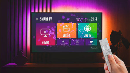 Man watching TV, remote control in hand. VOD service on TV