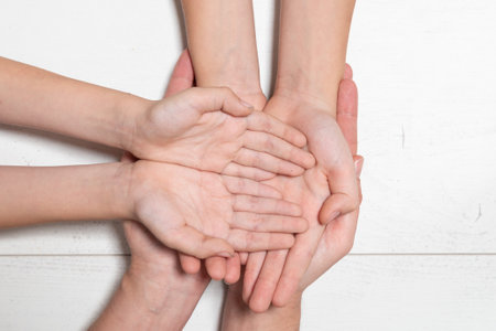 Concept of togetherness and strength, as the hands are tightly intertwined. The scene could represent a moment of solidarityの写真素材
