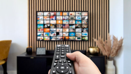 VOD multimedia TV streaming concept with hand holding remote controlの写真素材