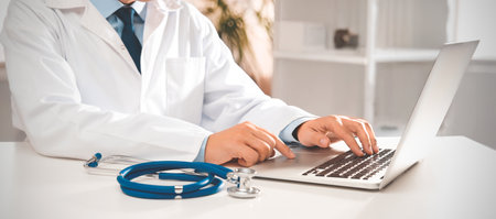 Doctor working in the office, stethoscope and laptop on deskの写真素材