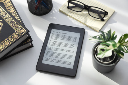 E-book reader device in home library, top viewの写真素材