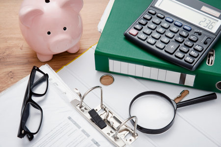 Savings money with piggy bank concept. Coins and papers on deskの写真素材
