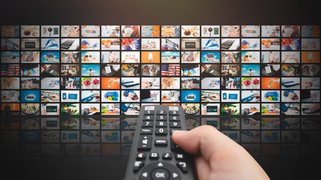 VOD multimedia TV streaming concept with hand holding remote control