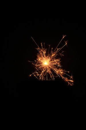 yellow sparks on a black background.の写真素材