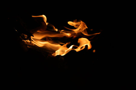 Fire flames on a black background close-up, abstract background.