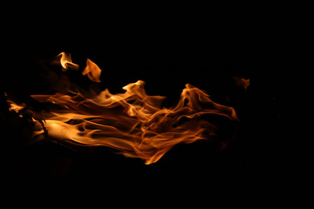 Fire flames on black background. Close up of fire flames isolated on black background.