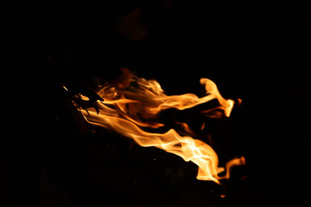 Fire flames on a black background, close-up, fire texture