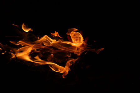 Fire flames on a black background close-up with room for text