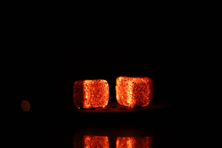 Glowing coals with glitch style lighting, enriched by noise, effect and grain details, create a...