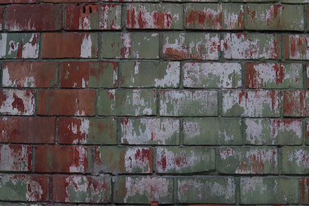Old brick wall with peeling paint. Abstract background and texture.