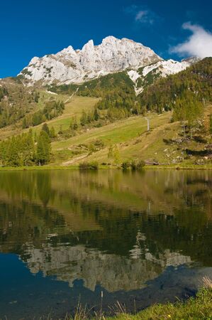 The Gartnerkofel reflected in a lake in Austriaの写真素材