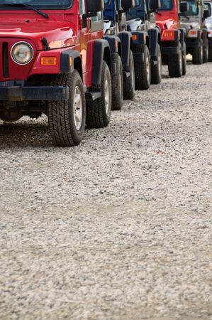 Many equal cross-country vehicals in a close convoyの写真素材