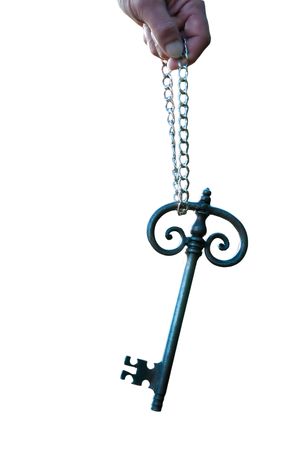 And old big sunlit key held with a chainの写真素材
