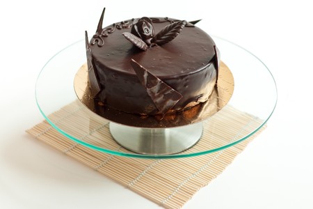 Chocolate cake on isolated background on glass plateの写真素材