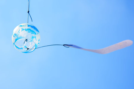 Japanese wind chime against blue skyの写真素材